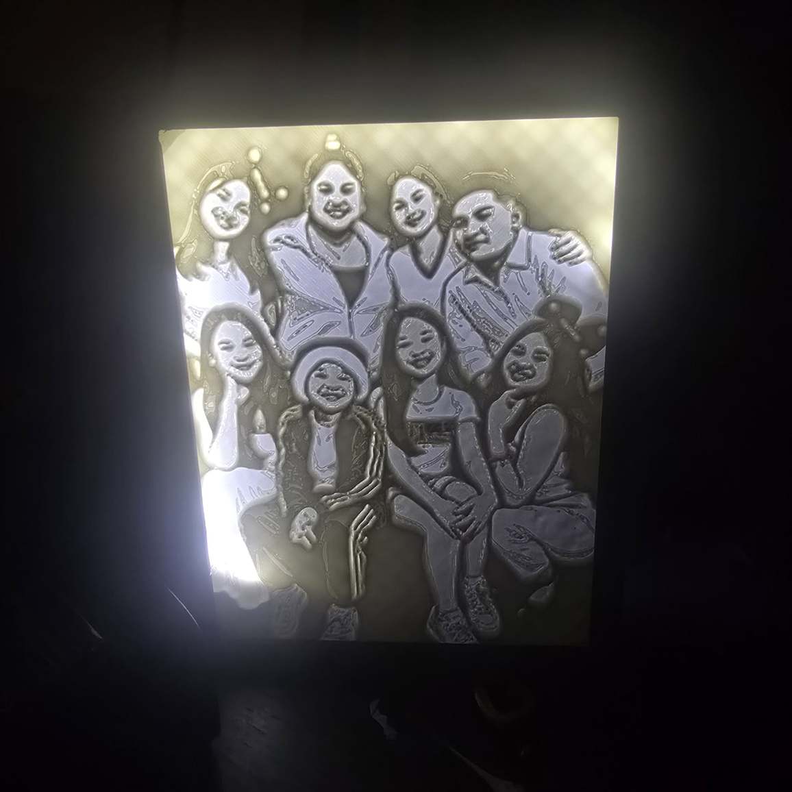 Custom photo lightbox with a family photo glowing through the printed panel