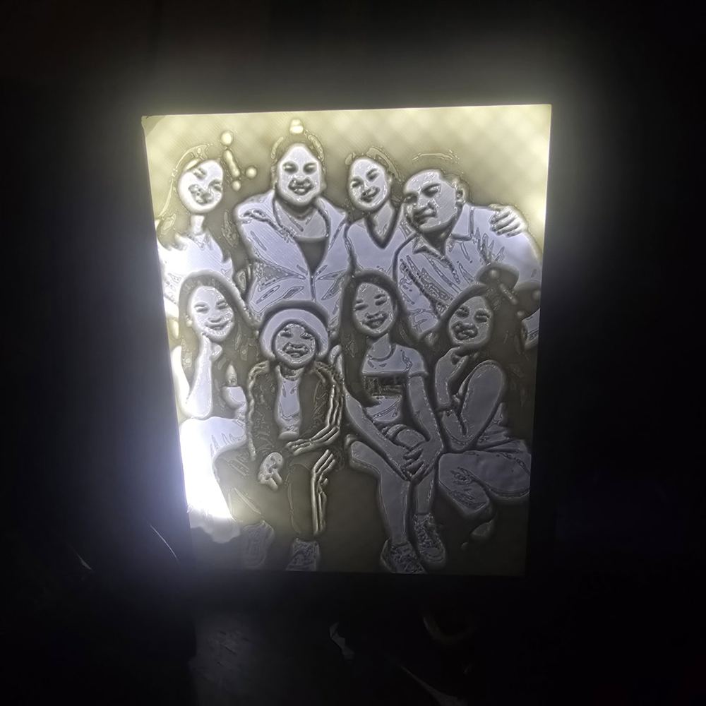 Custom photo lightbox with a family photo glowing through the printed panel